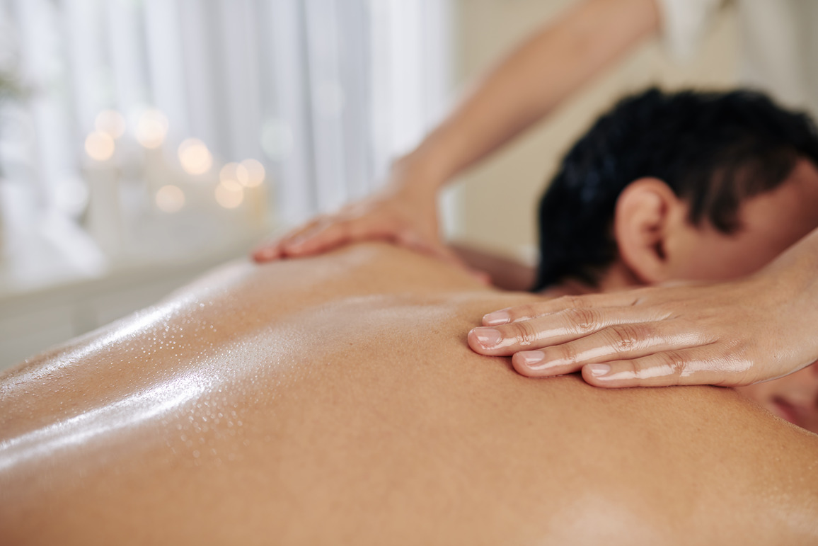 a woman giving an erotic massage to a man while laying down